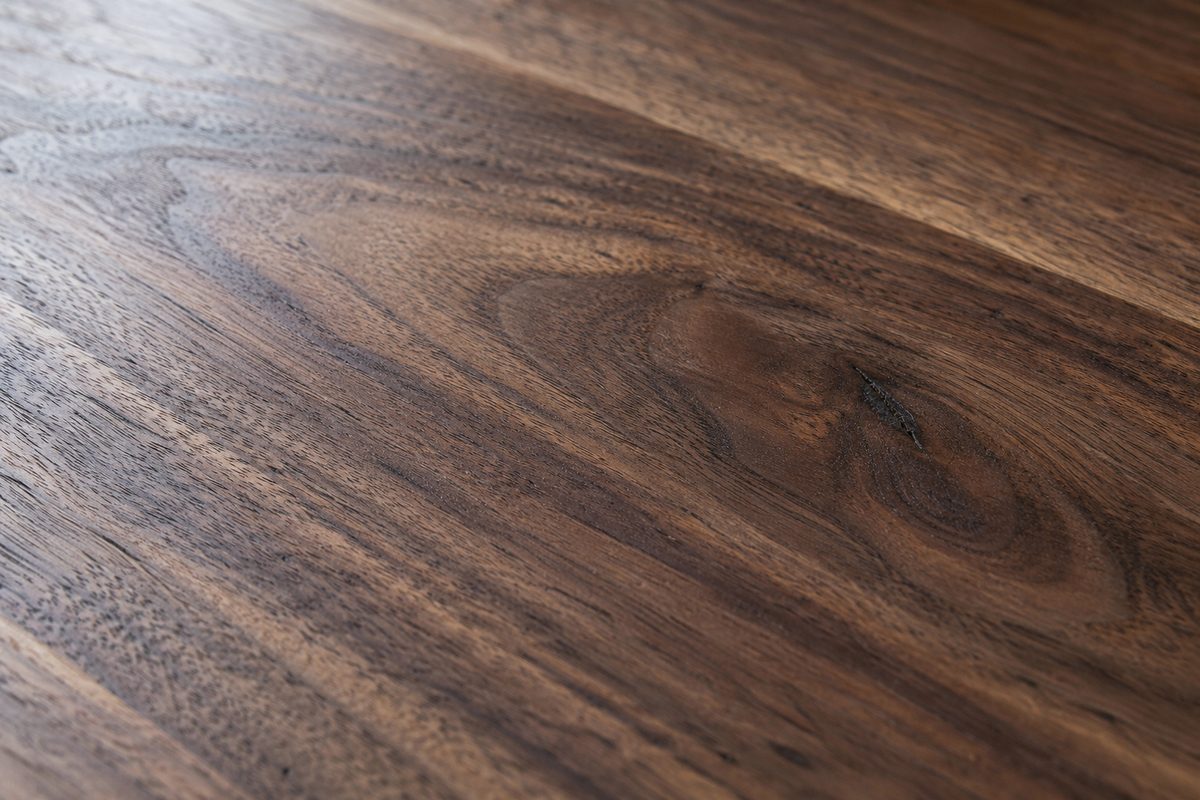 Macro photograph of natural American black walnut timber grain and oil finish.